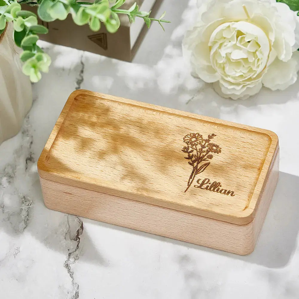 Close-up of laser-engraved birth flower and personalised name on a wooden jewellery box — handcrafted personalised keepsake