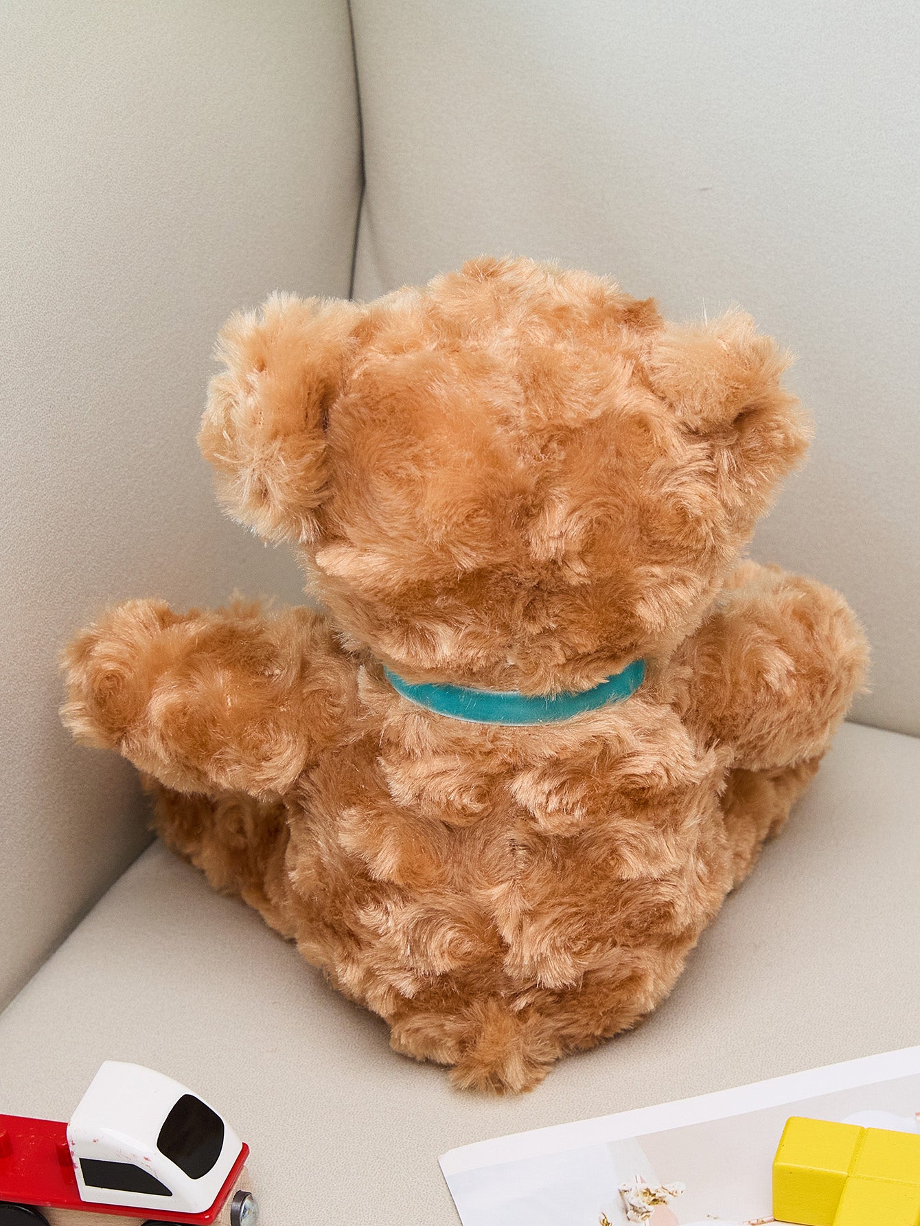 Handheld close-up showing embroidered details and soft plush fabric of the personalised birth announcement bear
