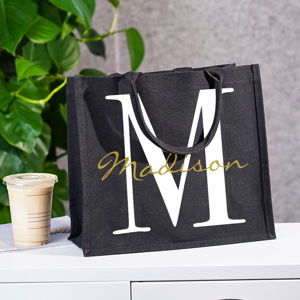 Multiple angle views of the personalised black canvas name and initial tote displaying front, side and back to show shape and depth (36×32×15cm)