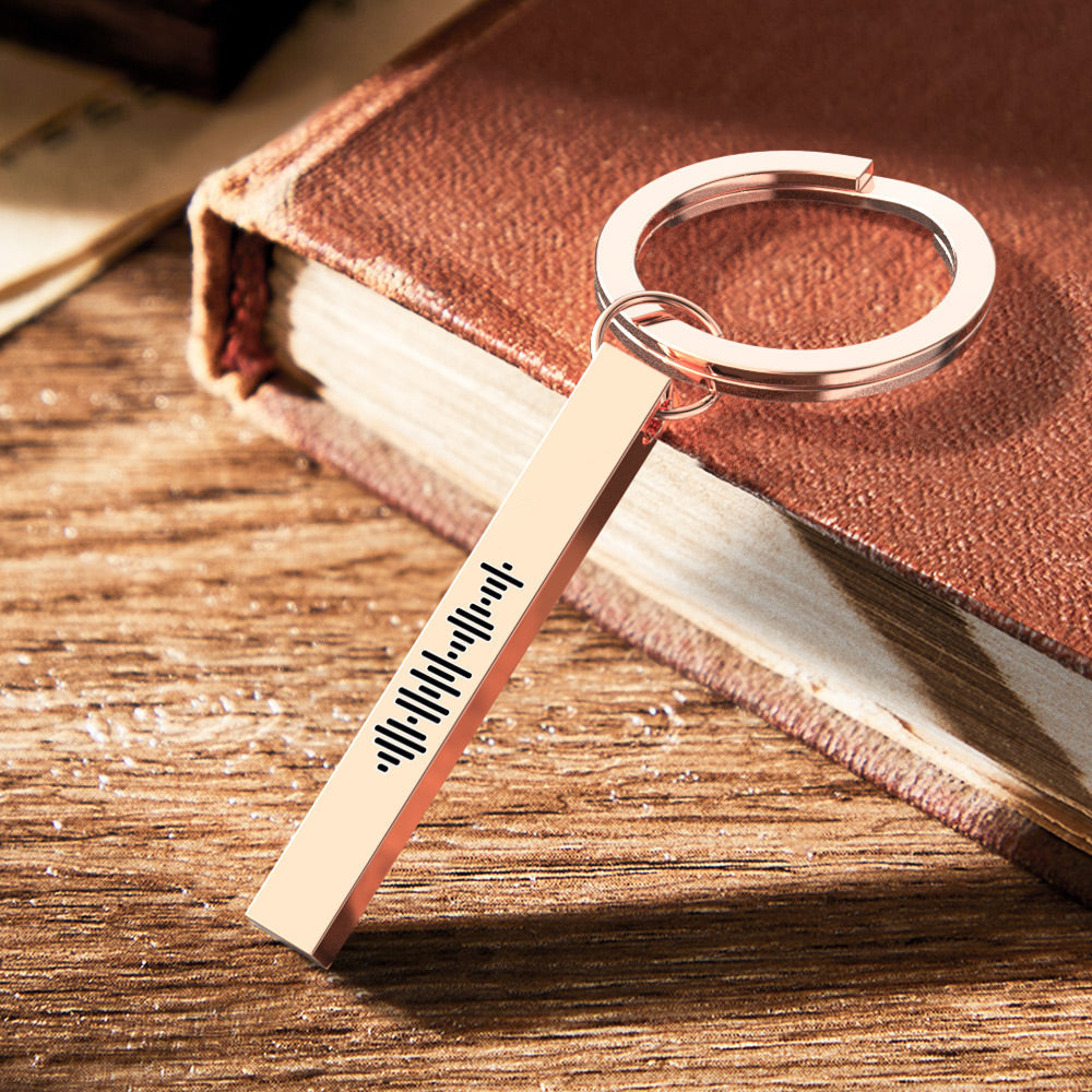 Hand-held view of personalised 3D bar keychain with scannable Spotify code demonstrating real-life scale and finish