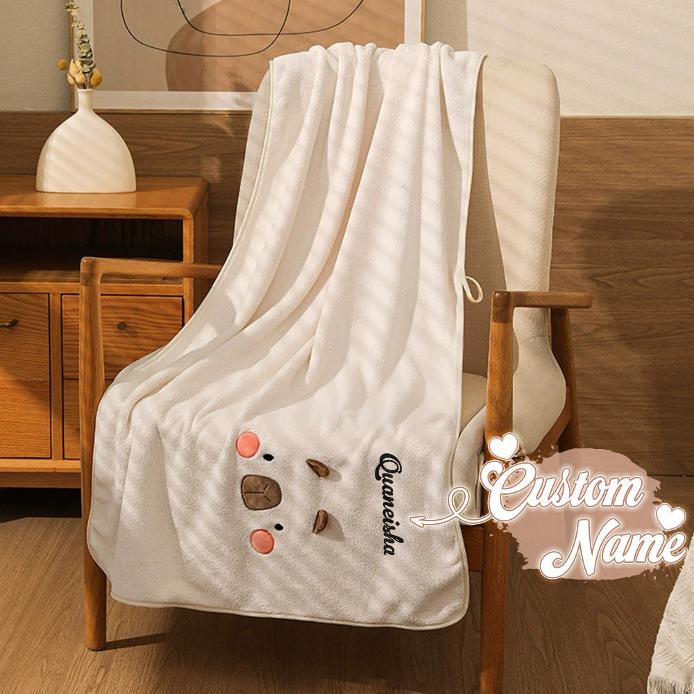 Close-up of embroidered name on personalised bath towel showing dense stitch detail and premium finish