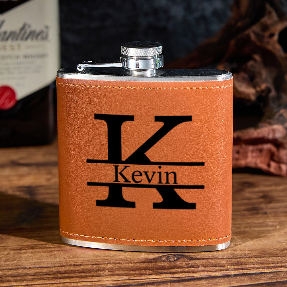 Angled view of a 6oz personalised stainless steel whisky flask showing the screw-top cap and engraved initials on premium PU leather — perfect Father's Day or groomsmen gift