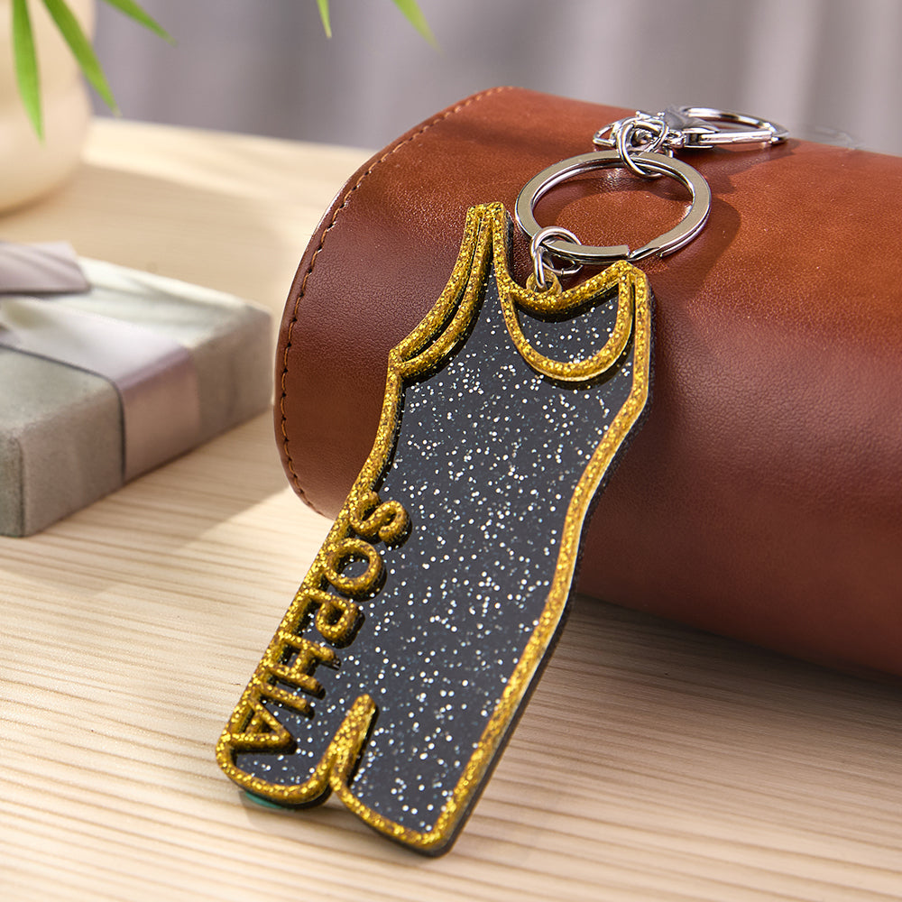 Row of personalised wrestling singlet keychains in different designs — team gift idea and tournament keepsakes, personalised keychain options