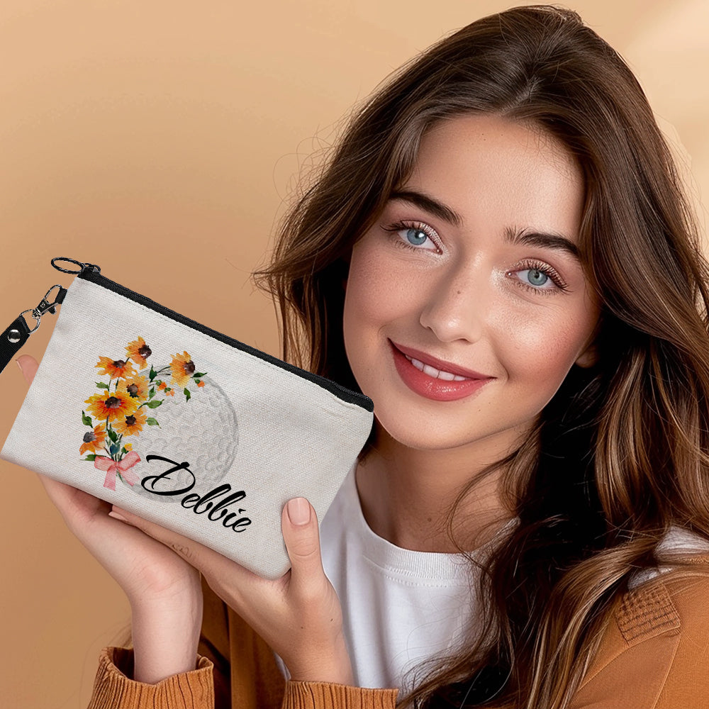 Personalised golf gift pouch styled with golf accessories — canvas makeup bag with birth flower print and golf ball motif, a thoughtful custom gift for golfers