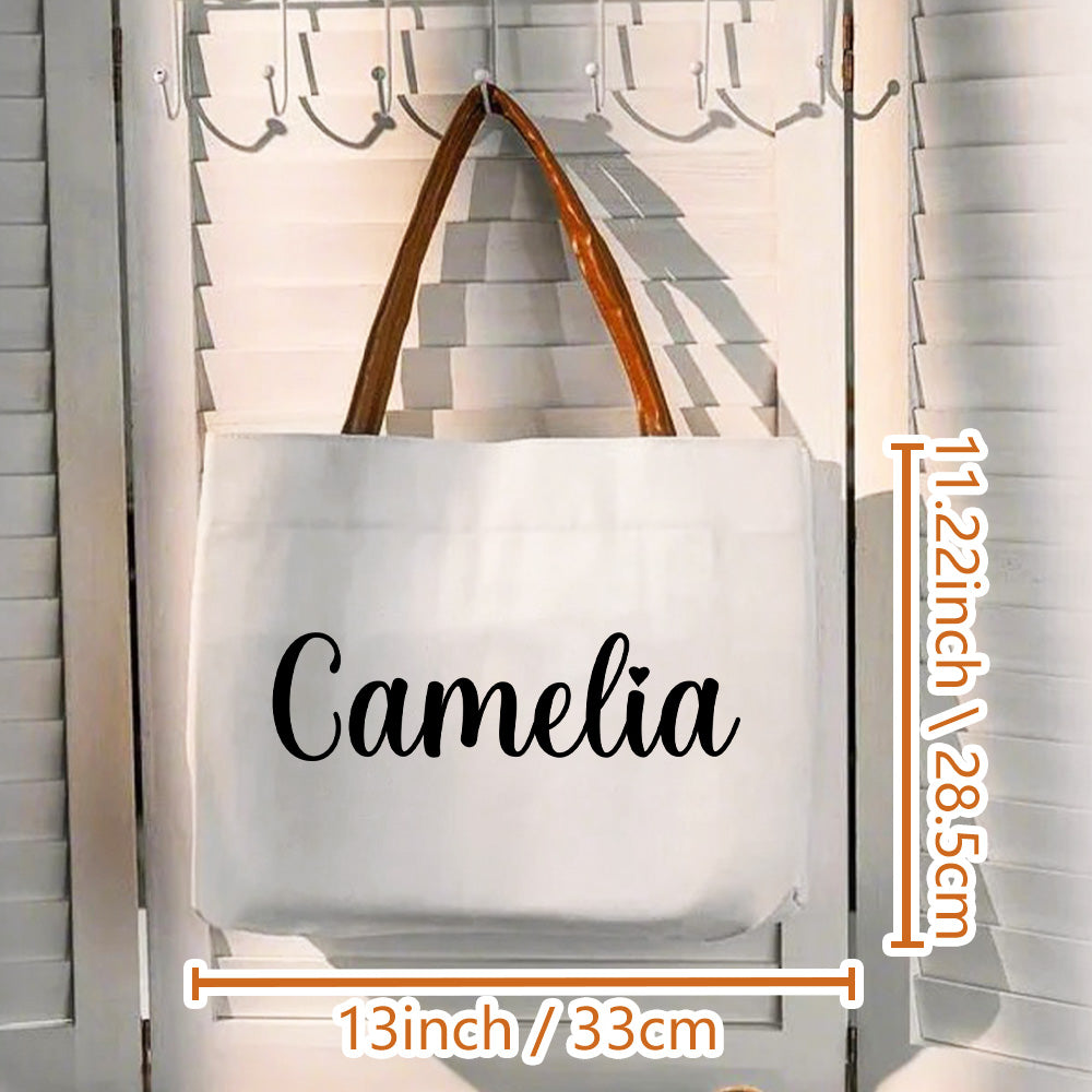 Lifestyle shot of personalised name canvas tote worn on the shoulder — versatile everyday shopper for work, study or dates