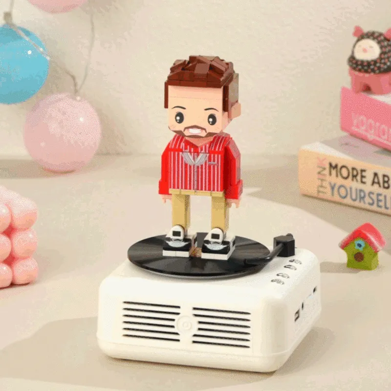 Customisable one-person full-body personalised brick figure seated on Bluetooth speaker base, front view — bespoke anniversary gift and custom brick figure speaker