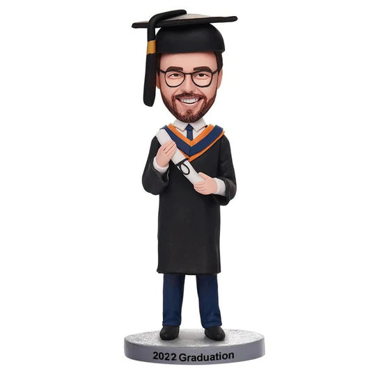 Personalised graduation man bobblehead in gown and mortarboard holding diploma with engraved base, custom polymer clay bobblehead bespoke graduation keepsake