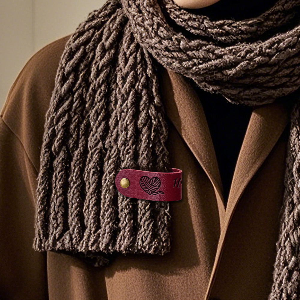 Close-up of custom PVC label sewn onto a jumper, personalised brand tag