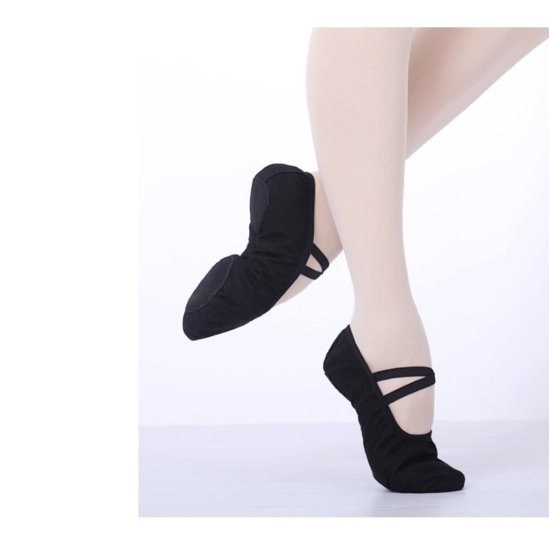 Young dancer practising plié wearing pink canvas split sole ballet shoes demonstrating breathable comfort and flexible sole for training