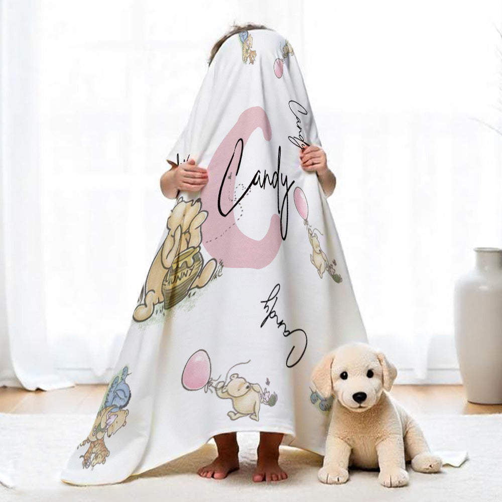 Blanket folded to show Pooh design and soft fabric texture.