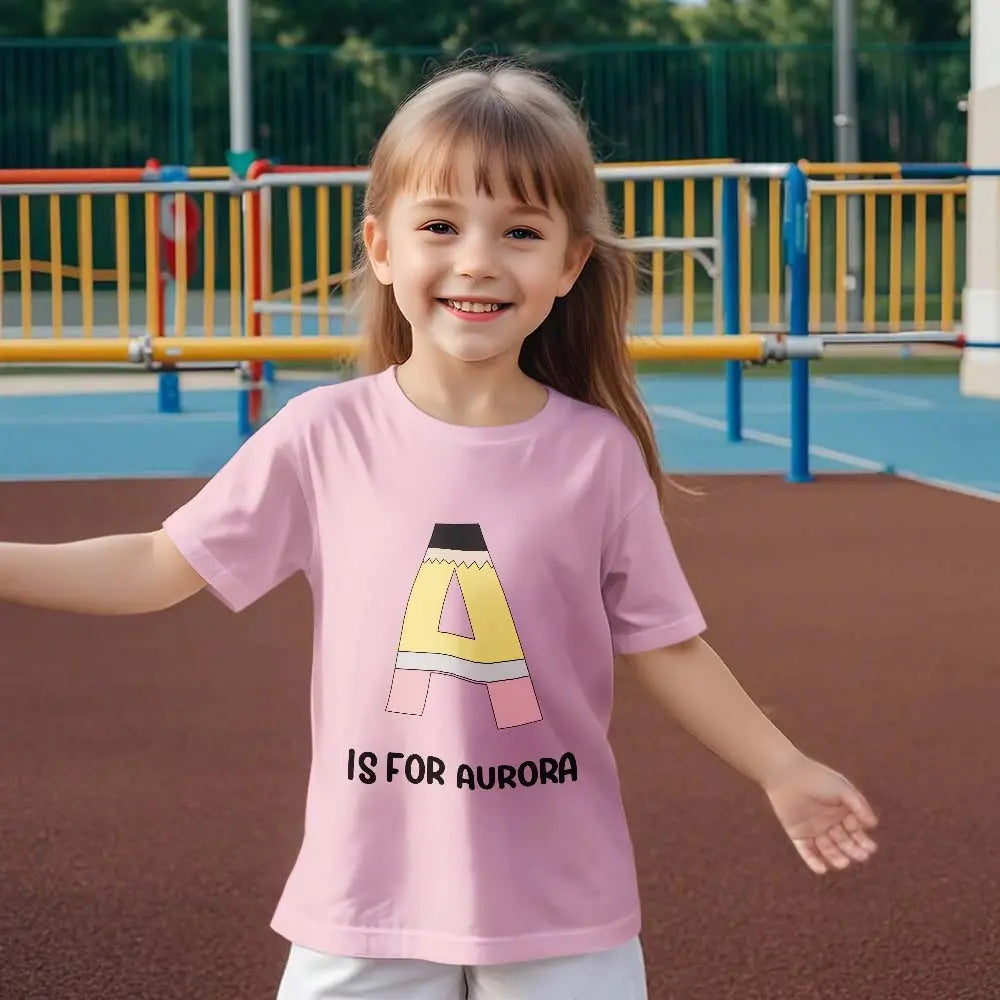 Child smiling in personalised pencil t‑shirt on first day of school — memorable personalised keepsake and birthday gift option