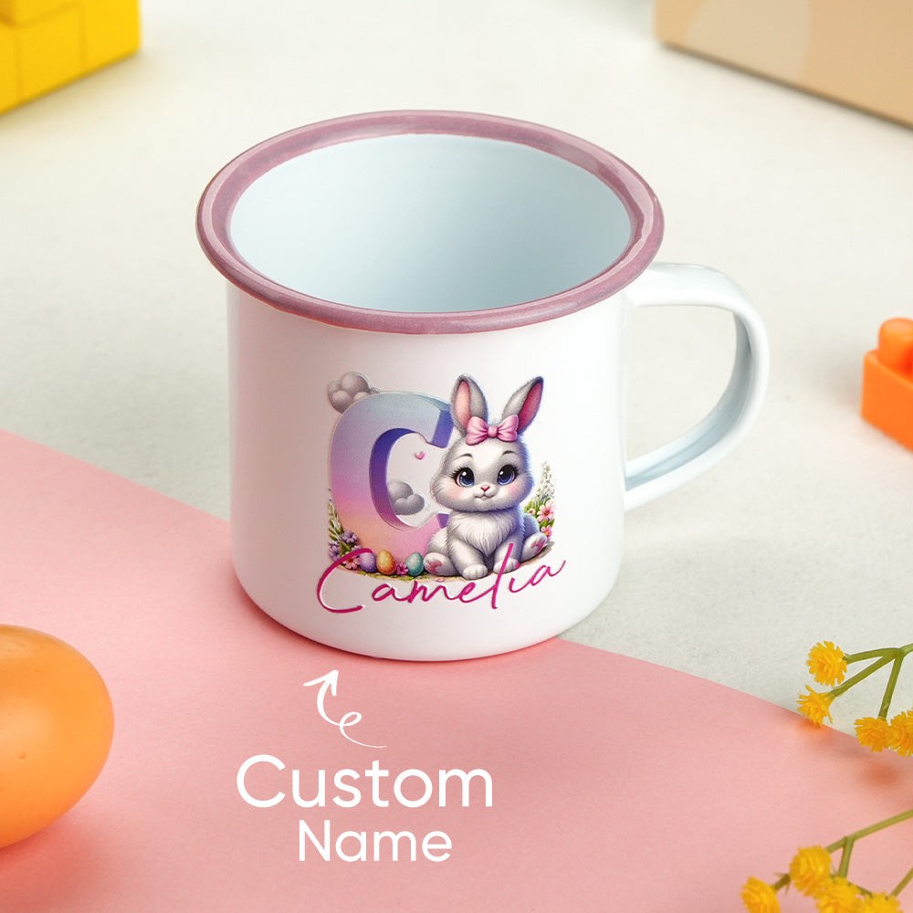 Personalised bunny enamel mug used as a pen pot on a child's art table — versatile, colourful children's gift with gradient initial