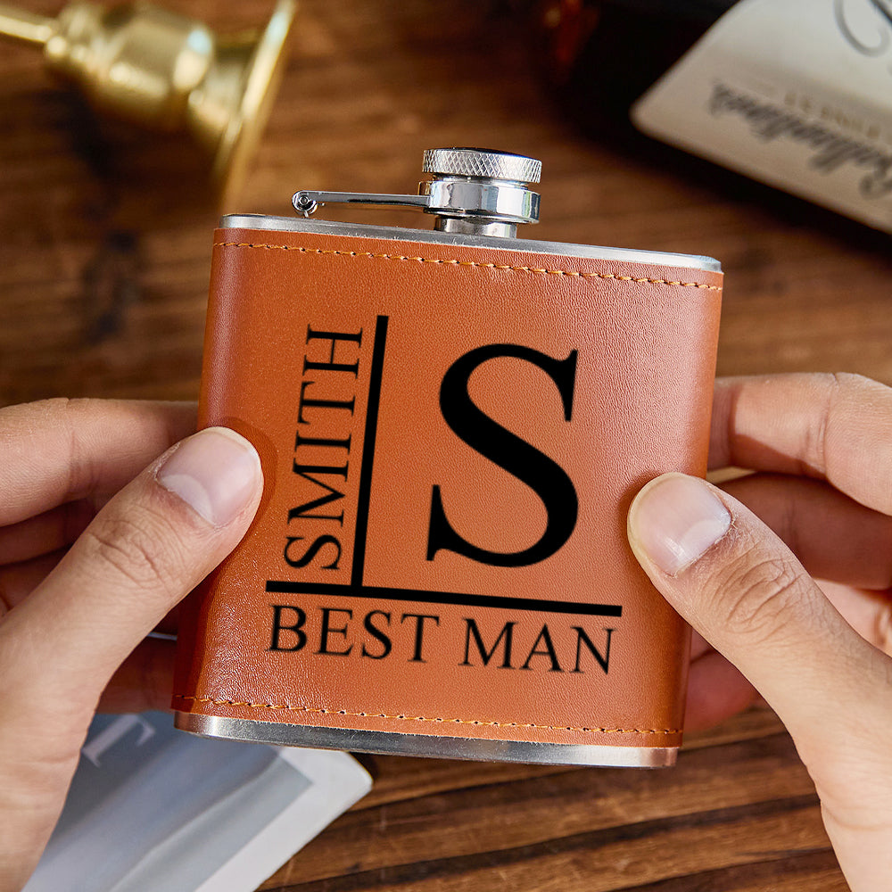 Close-up of engraved name on PU leather wrap and screw cap of 6oz stainless steel whisky flask - ideal groomsmen or Father's Day gift
