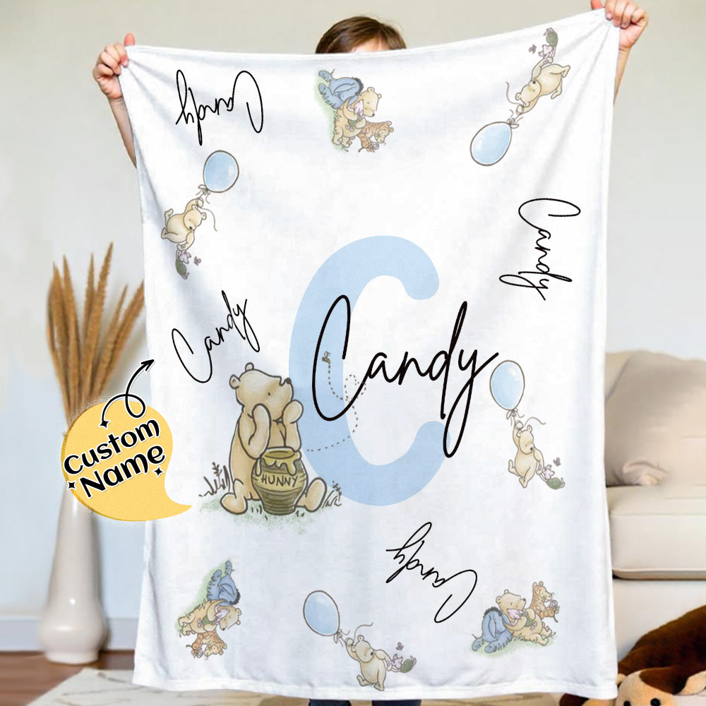 Side view of the Pooh name blanket highlighting plush flannel material.