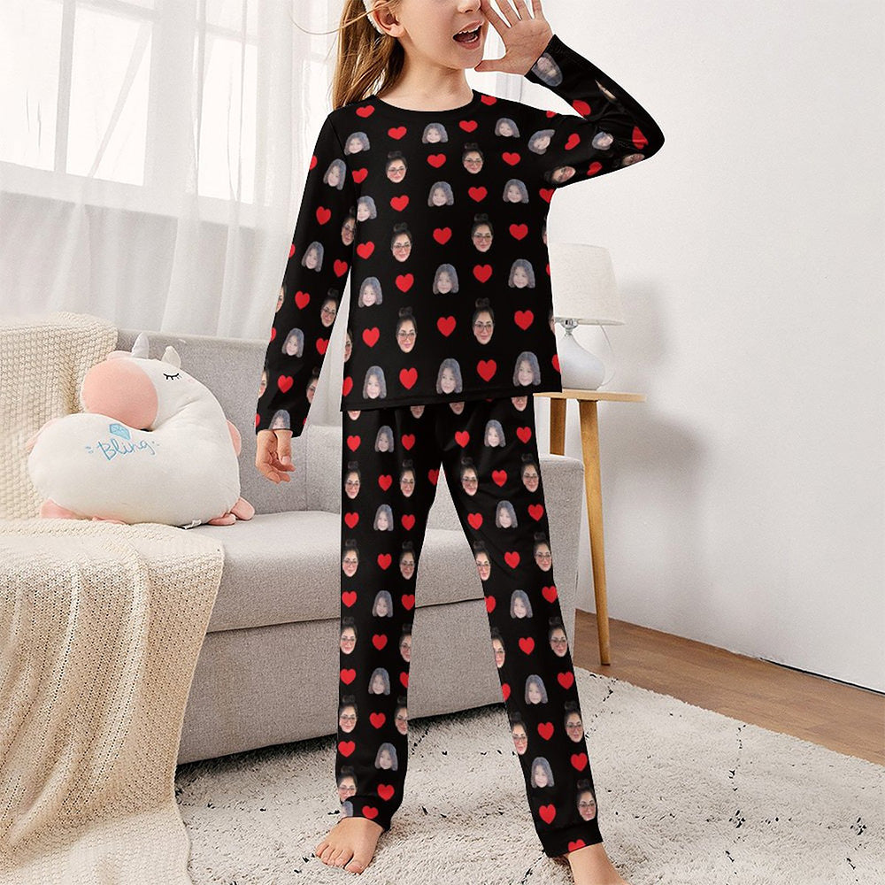 Girl modelling the custom two‑face pyjama set, long‑sleeve top and matching trousers — personalised kids' sleepwear