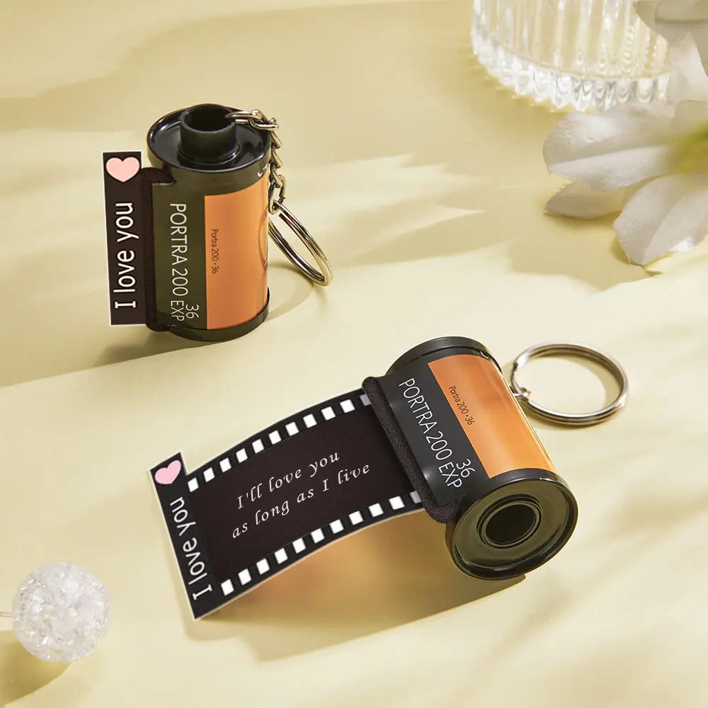 Vintage-style film reel keychain with sturdy metal loop and durable recycled-plastic reel — tested for long-lasting use