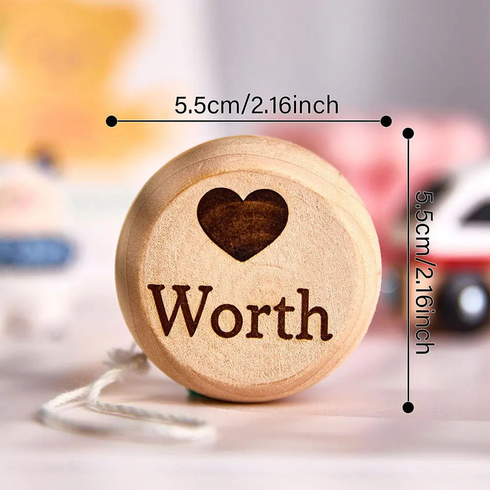 Close-up detail of an engraved name on a wooden yo-yo — precise custom engraving for a unique kids' keepsake