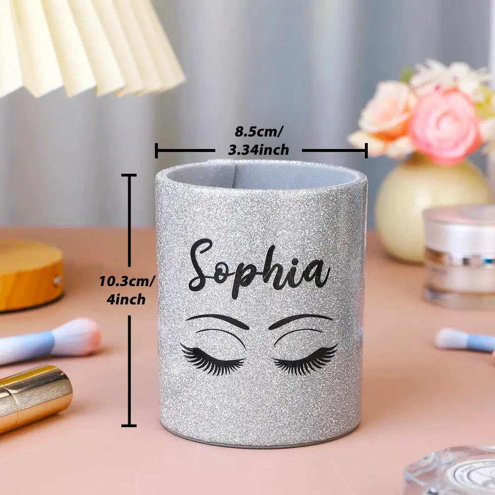 Styled dressing table scene with personalised glitter leather brush cup beside perfume and cosmetics, showing decorative and practical use for a vanity organiser