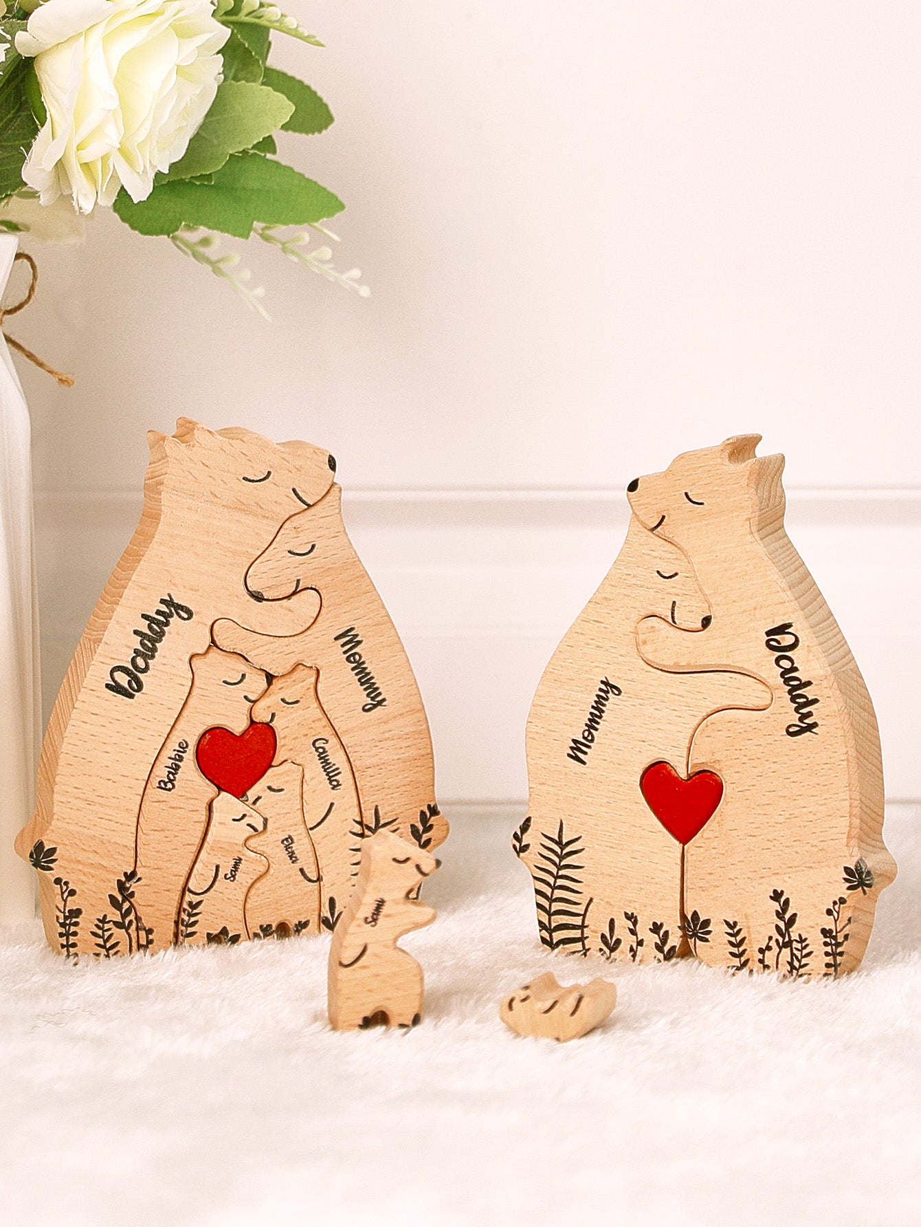 Close-up of personalised wooden heart bear puzzle showing precise laser engraving of names and heart motifs