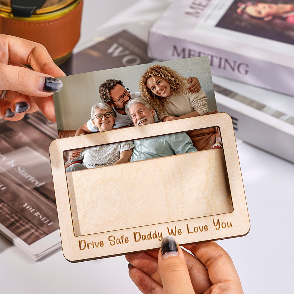Magnetic photo frame clipped to a car sun visor for easy visibility.