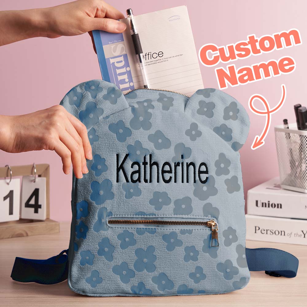 Angled shot showing personalised embroidered name, floral motif and durable zip on the mini flower canvas backpack — ideal personalised school bag for children
