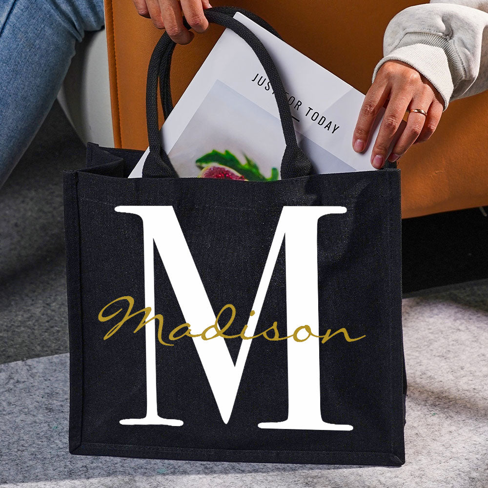 Gift inspiration image showing the personalised black canvas name and initial tote as a thoughtful present for mum, wife, sister or teacher