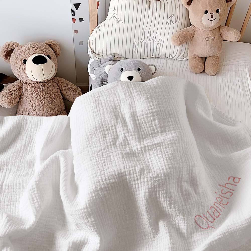 Embroidery detail on the baby blanket, highlighting heirloom-quality stitching.