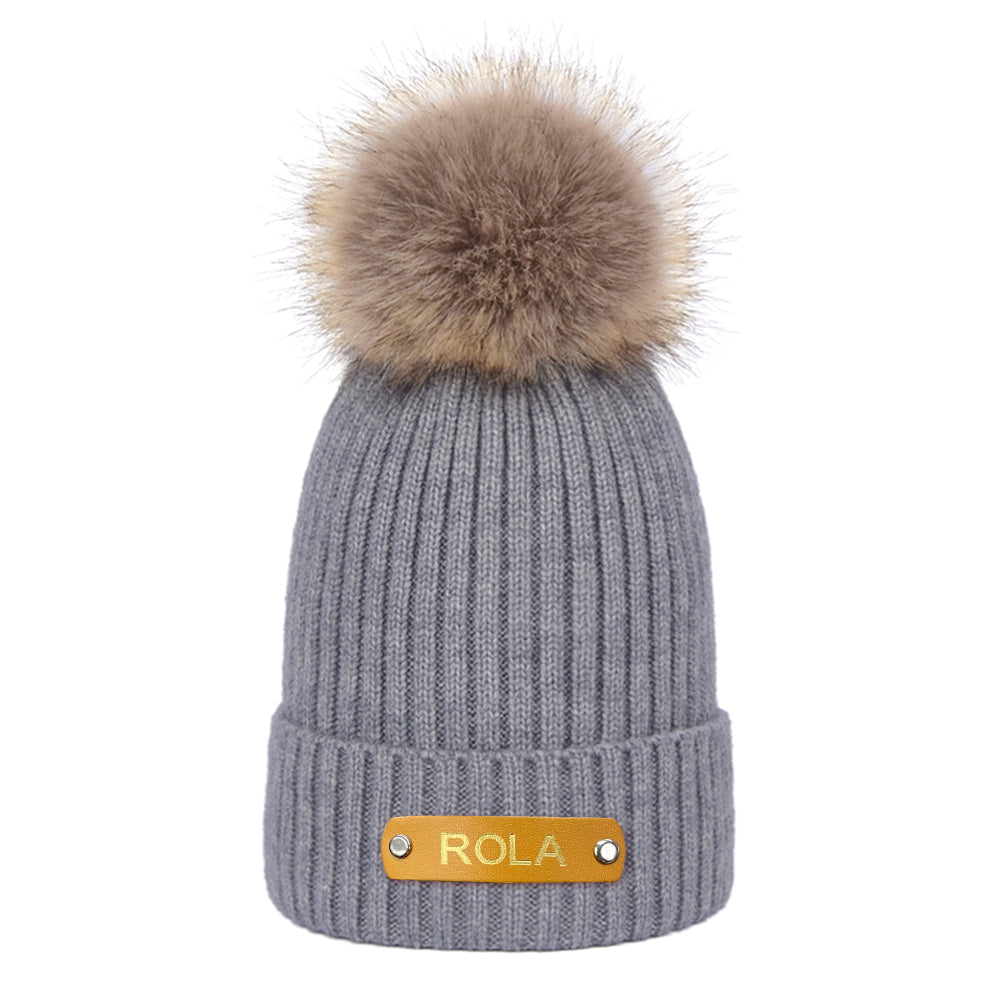 Personalised baby beanie folded to show interior stretch and secure construction — safe newborn winter hat design