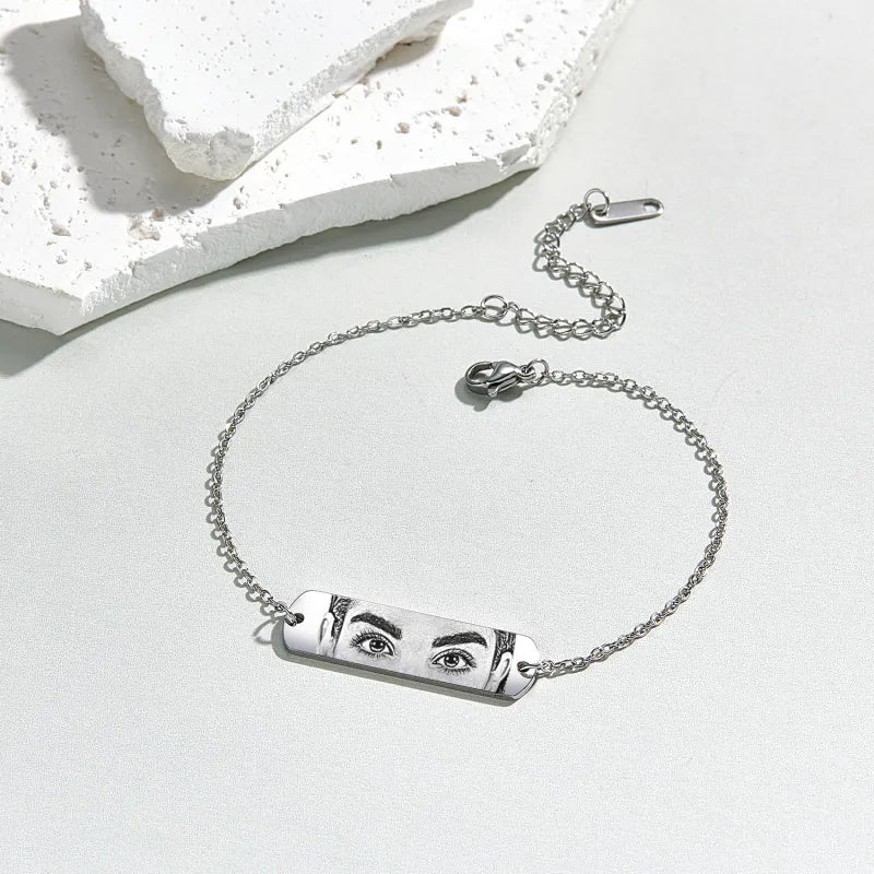 Woman wearing a personalised photo bracelet close-up, engraved custom photo pendant ideal as an anniversary or birthday gift for her