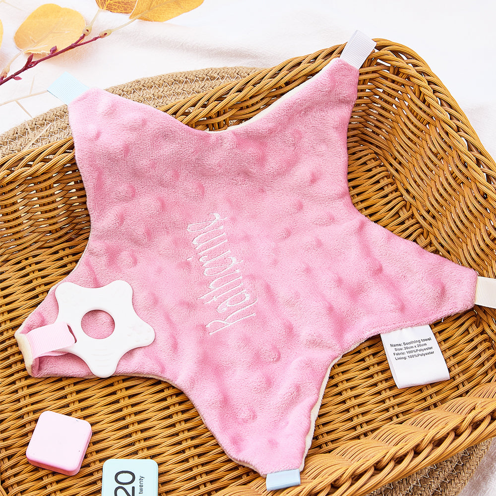 Personalised embroidered-name star comforter styled in a nursery — calming cotton companion for nap time and travel
