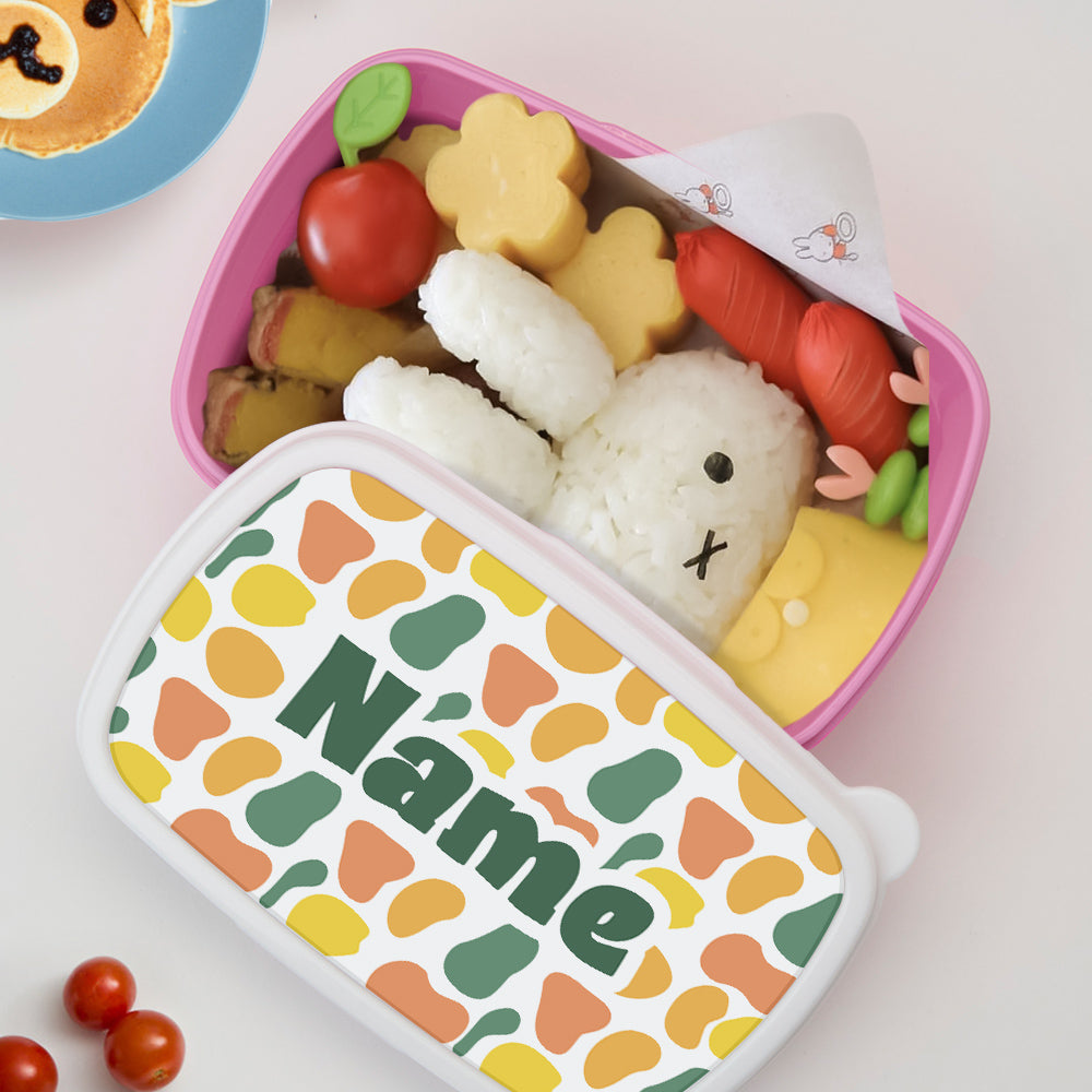 Close-up of colourful pattern and personalised name on the lunch box lid — children's named lunch box for classroom and birthday gifts