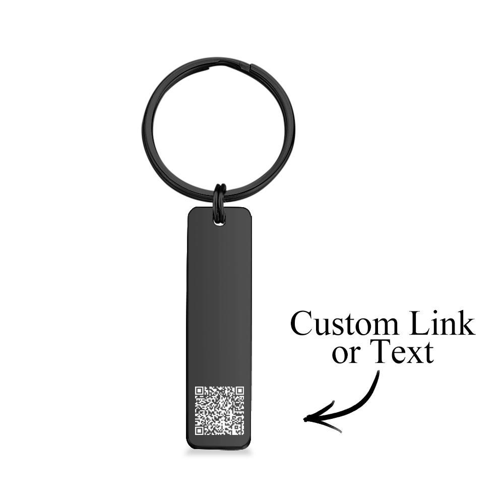 Personalised engraved QR code keychain shown in hand for scale, durable corrosion-resistant stainless steel with crisp laser engraving for reliable scanning