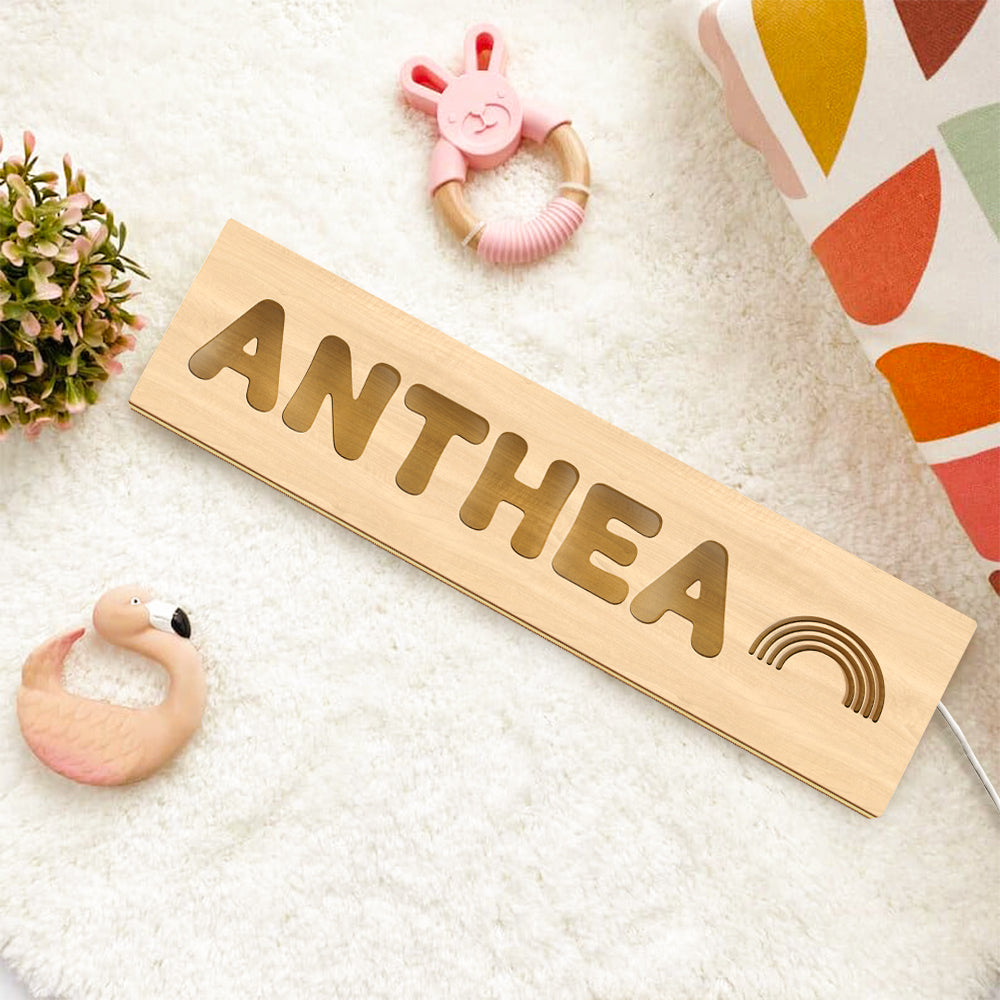 Close-up of precision laser engraving and natural wood grain on a personalised baby night light — engraved name lamp detail
