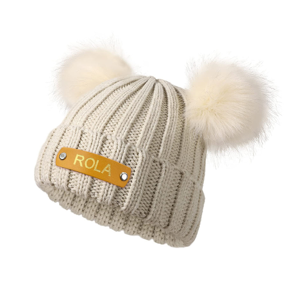 Personalised baby beanie in soft pink with a hot-stamped custom name leather patch – ideal newborn gift
