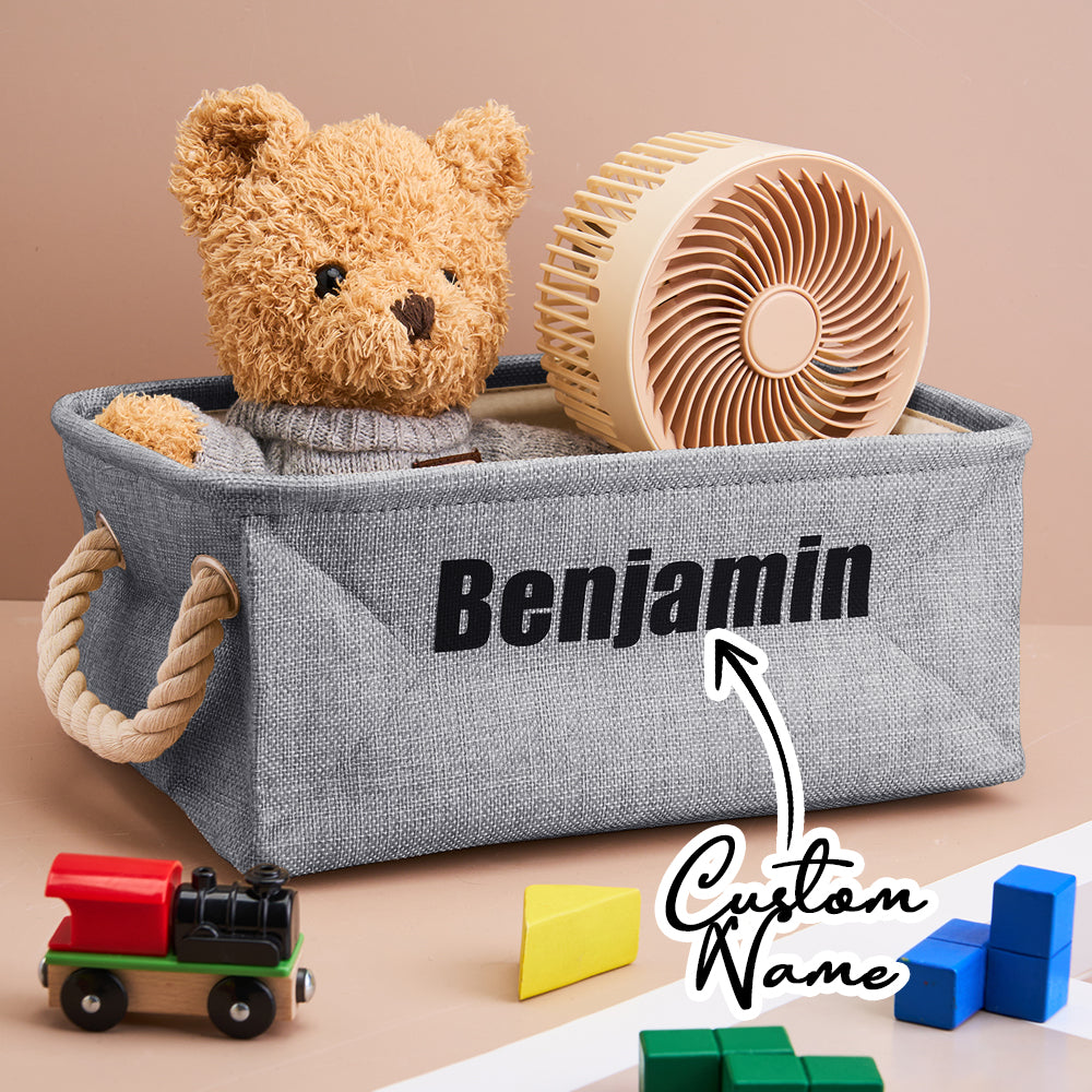 Front view of a personalised linen toy storage basket with name; neutral nursery organiser in open-top design.