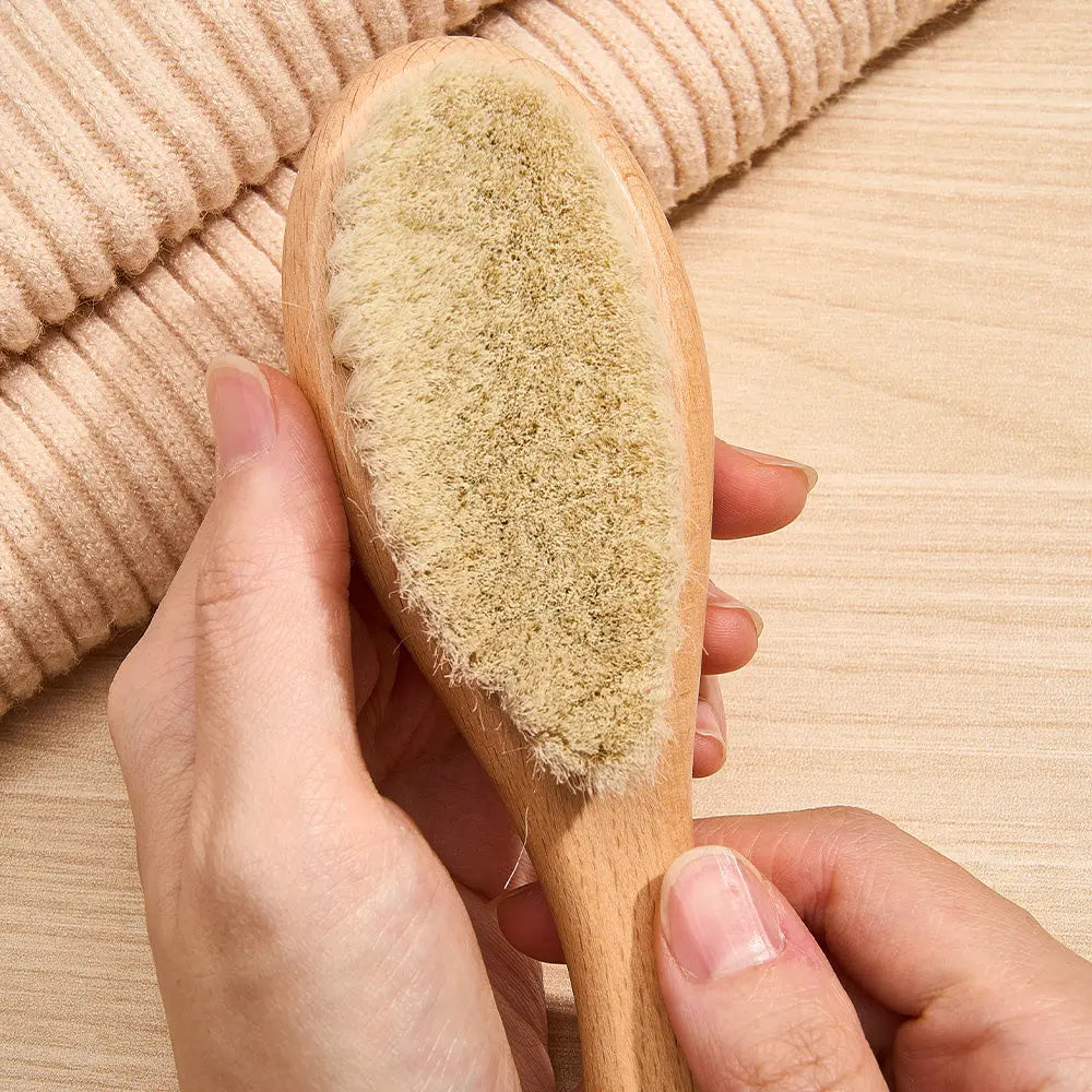 Wooden baby comb showing smooth, rounded teeth to protect the scalp — essential piece of a personalised newborn grooming set
