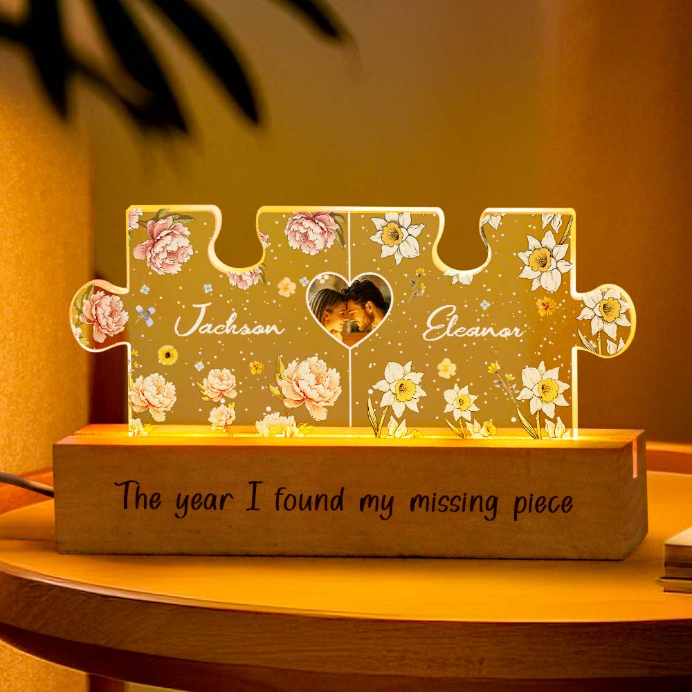 Angled view of personalised couple puzzle night light glowing with warm LED light, highlighting birth flower customisation and romantic ambience