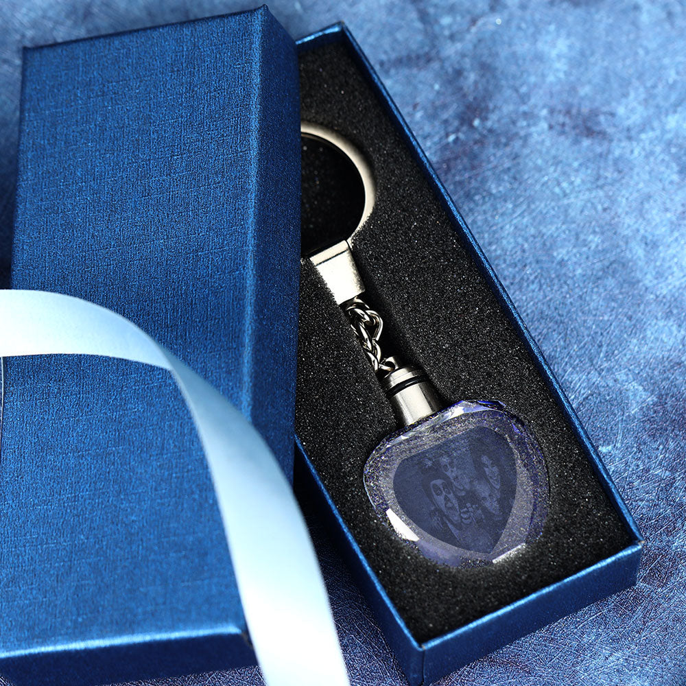 Heart-shaped crystal keyring illuminated by the LED base showing multicolour gradient — personalised engraved photo gift for weddings and anniversaries