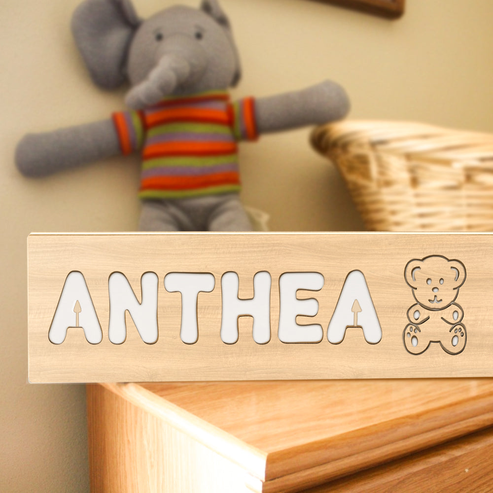 Engraved name close-up on a wooden panel of a personalised baby night light demonstrating fine laser-cut detail — engraved name lamp