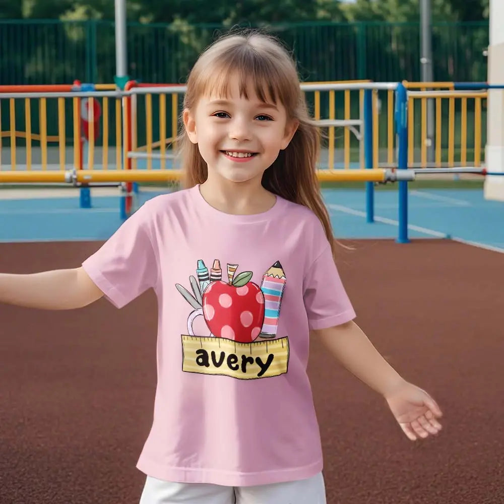 Girl modelling personalised back to school T-shirt for first day photograph with custom name visible