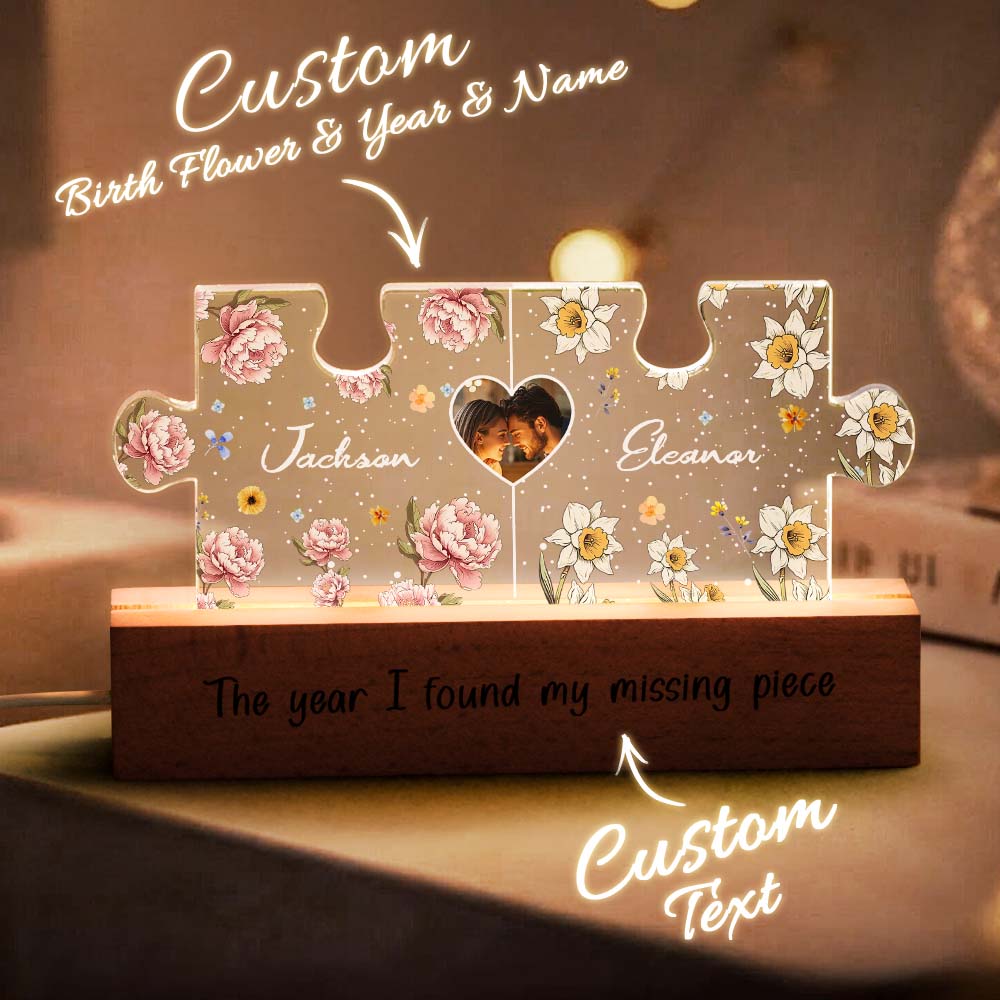 Close-up of laser-etched intertwined names in puzzle design on acrylic panel, personalised LED night light detail for couples
