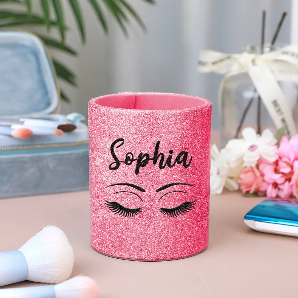 Compact personalised leather brush cup shown packed in a makeup bag, highlighting portability and suitability as a travel brush organiser