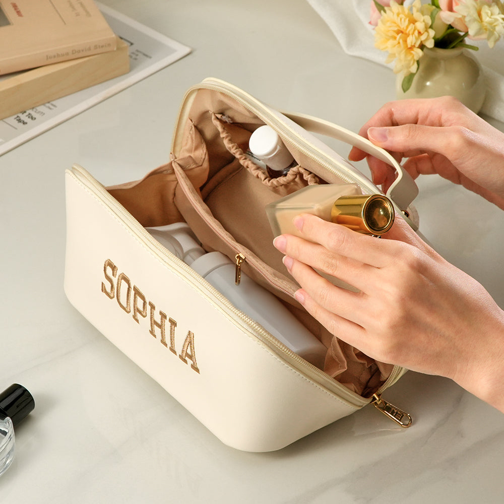 Top-down view of personalised PU leather makeup bag highlighting embroidered name and durable zipper – stylish travel gift for women
