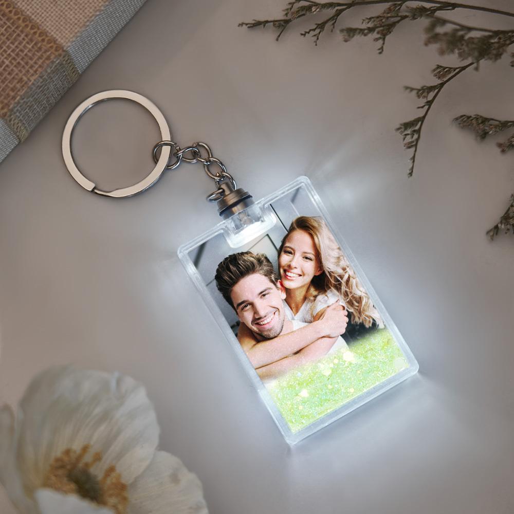 Angled shot of illuminated quicksand keychain highlighting durable acrylic body, LED light and clear personalised photo insert