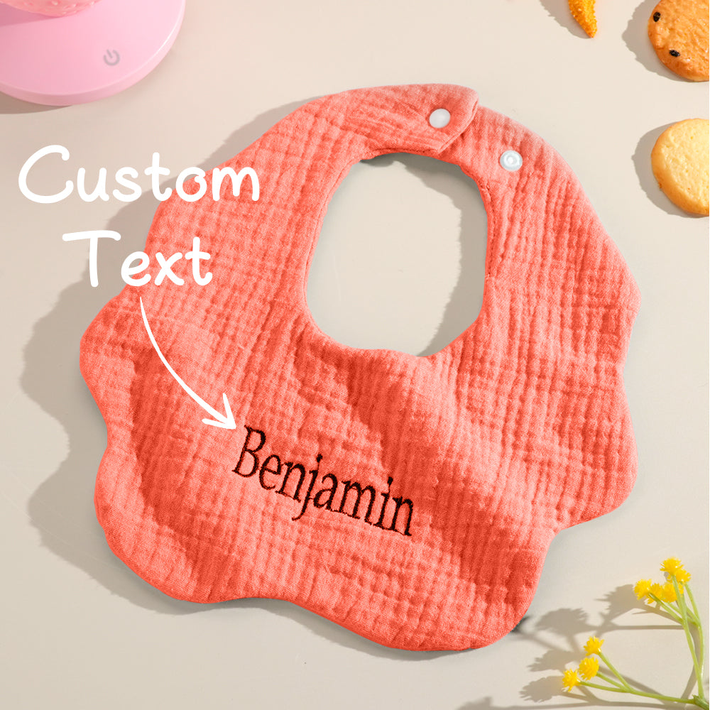Close-up of embroidered name on a personalised baby bib showing neat stitching — embroidered name bib detail