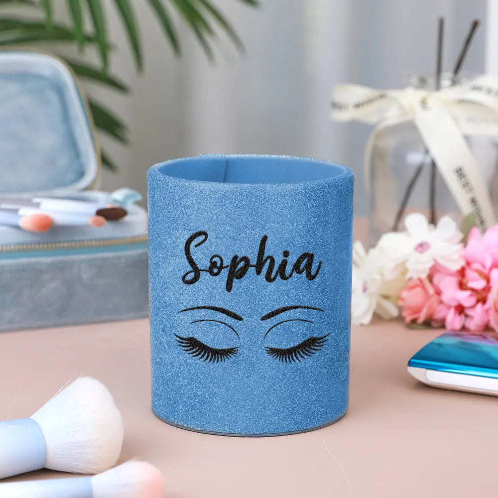 Selection of personalised glitter leather brush cups displayed together to show custom name options and styling variations in the collection