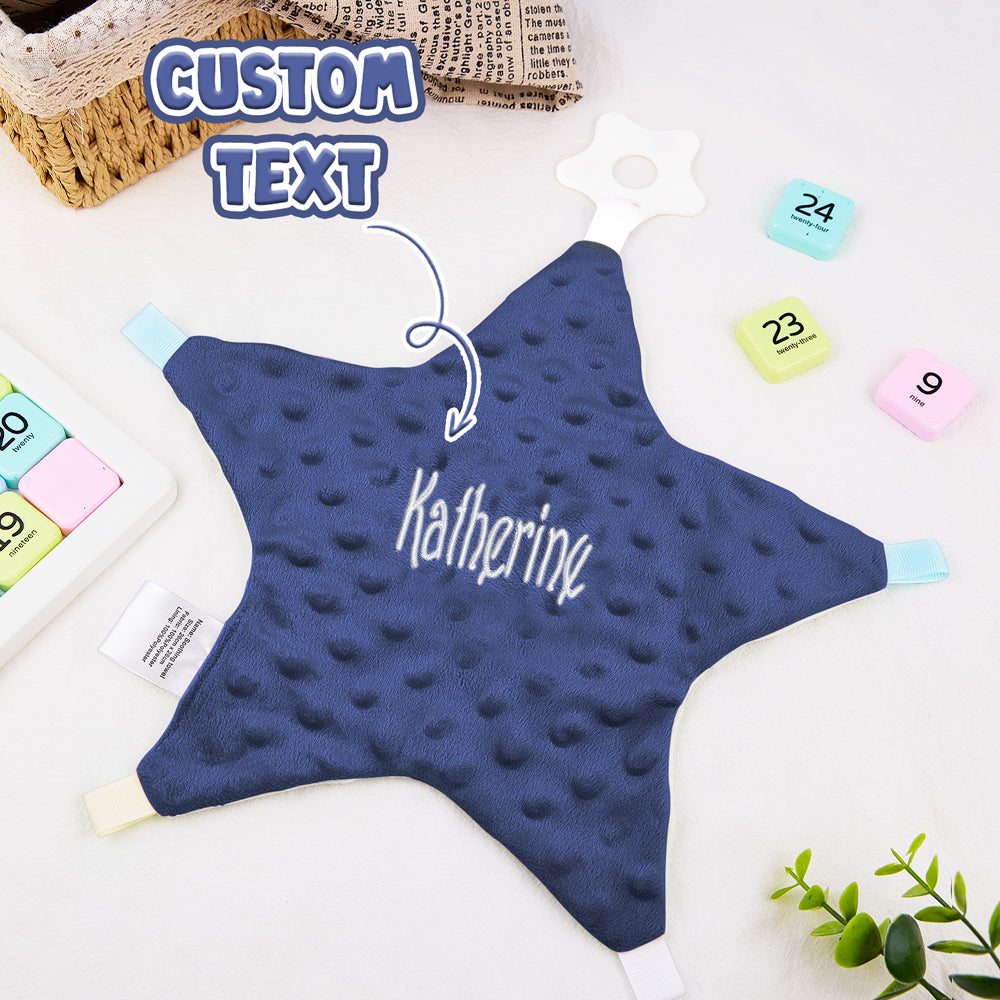 Close-up of embroidered name on a personalised star cotton baby comforter, showing fine stitching and soft cotton texture