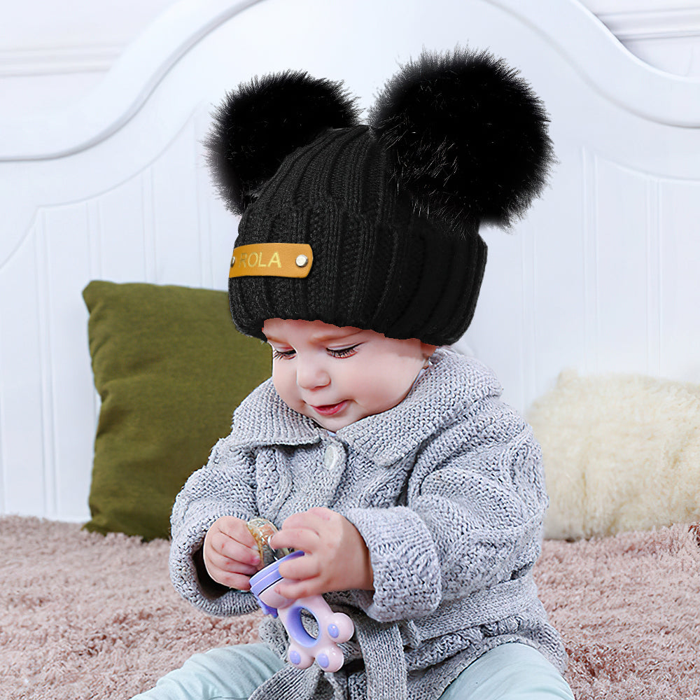 Interior and quality inspection view showing durable acrylic knit and stitching on a personalised baby beanie with name patch