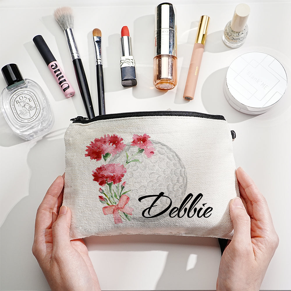 Personalised canvas makeup bag front view showing custom name, birth flower illustration and golf ball motif — durable travel cosmetics pouch with secure zip closure