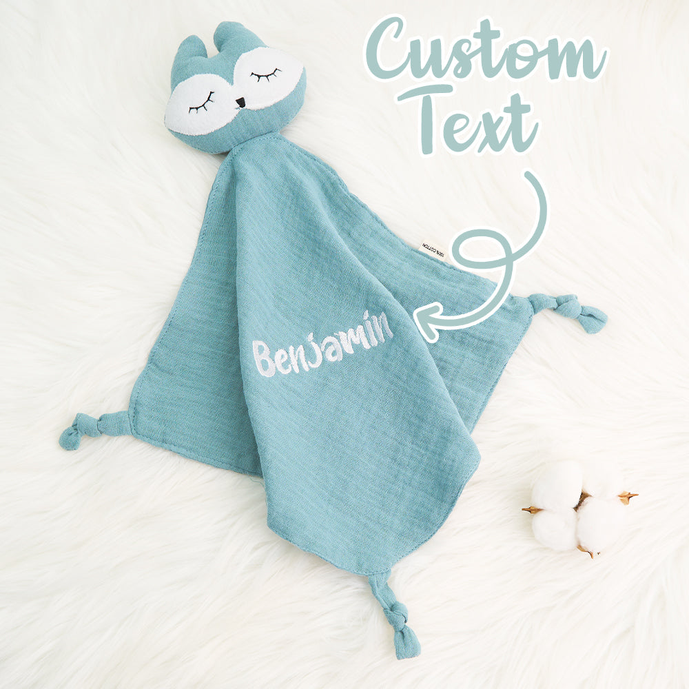 Size comparison showing a 24cm x 24cm personalised comfort towel in a baby's hand — compact, soft and ideal for cuddles and travel